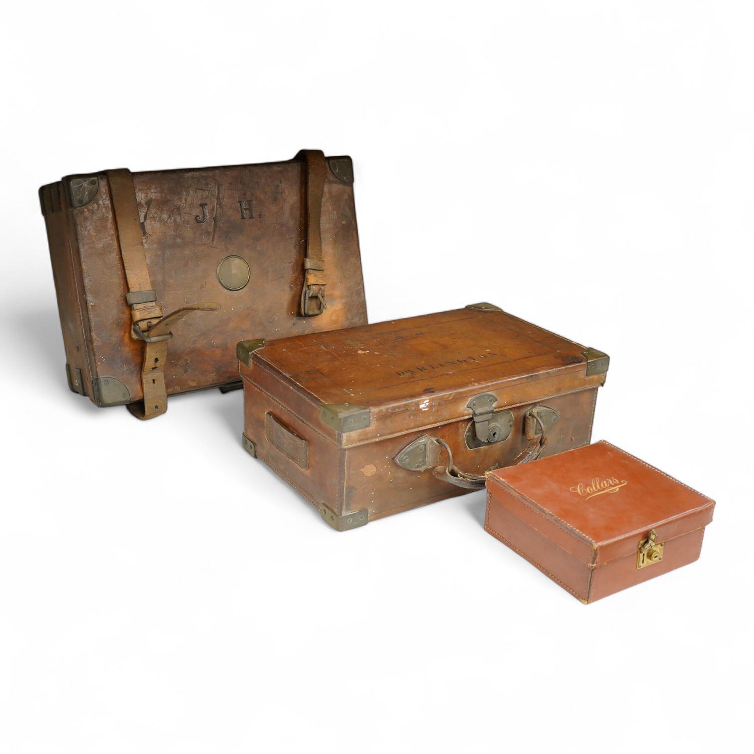 Two late 19th century brown leather magazine cases and another ‘collars’ box, largest 41cm wide